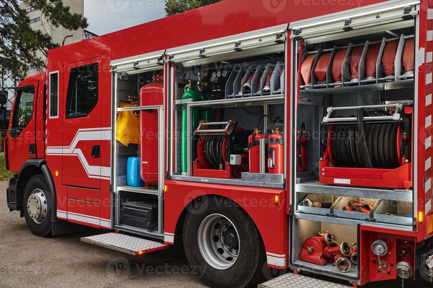 A state-of-the-art firetruck, equipped with advanced rescue technology, stands ready with its skilled firefighting team, prepared to intervene and respond rapidly to emergencies, ensuring the safety photo