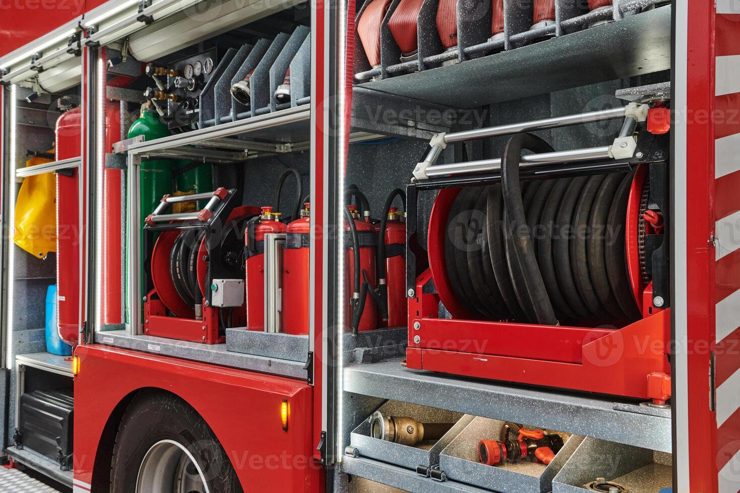 A state-of-the-art firetruck, equipped with advanced rescue technology, stands ready with its skilled firefighting team, prepared to intervene and respond rapidly to emergencies, ensuring the safety photo