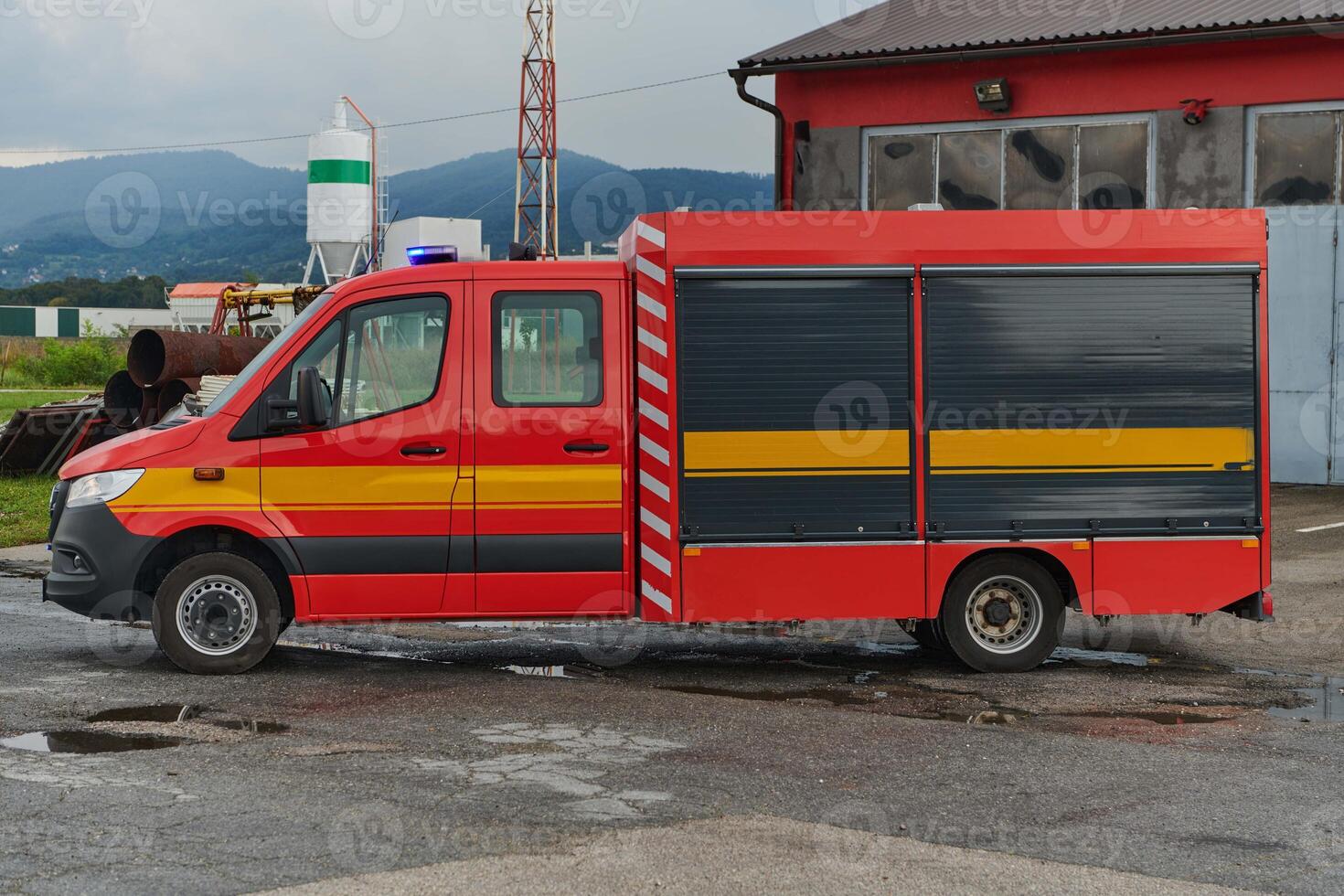 A state-of-the-art firetruck, equipped with advanced rescue technology, stands ready with its skilled firefighting team, prepared to intervene and respond rapidly to emergencies, ensuring the safety photo