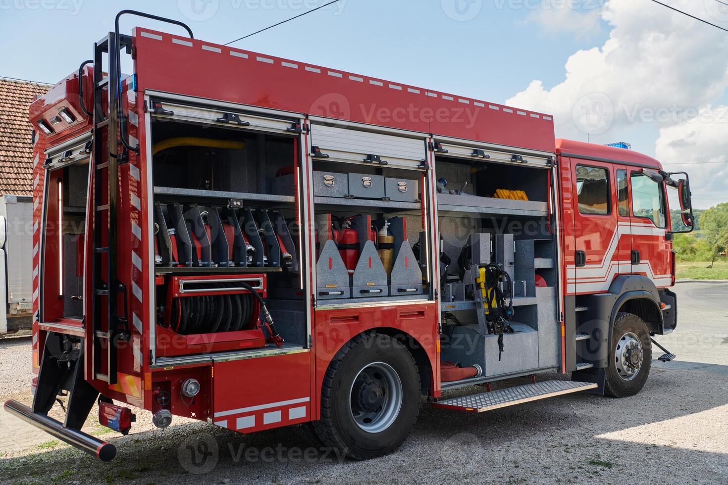A state-of-the-art firetruck, equipped with advanced rescue technology, stands ready with its skilled firefighting team, prepared to intervene and respond rapidly to emergencies, ensuring the safety photo