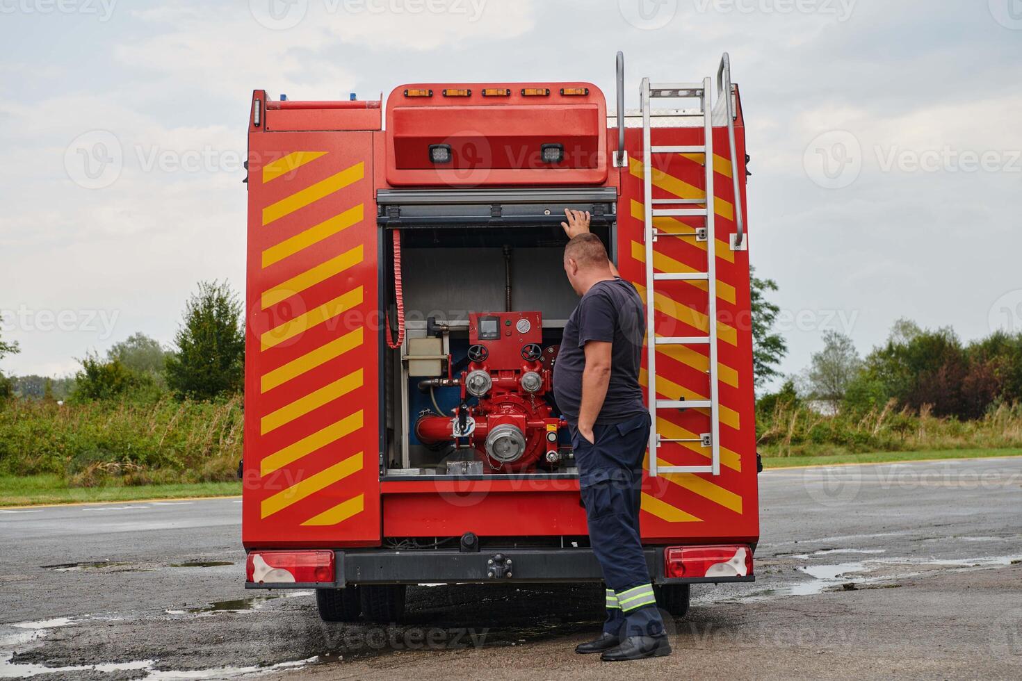 A state-of-the-art firetruck, equipped with advanced rescue technology, stands ready with its skilled firefighting team, prepared to intervene and respond rapidly to emergencies, ensuring the safety photo