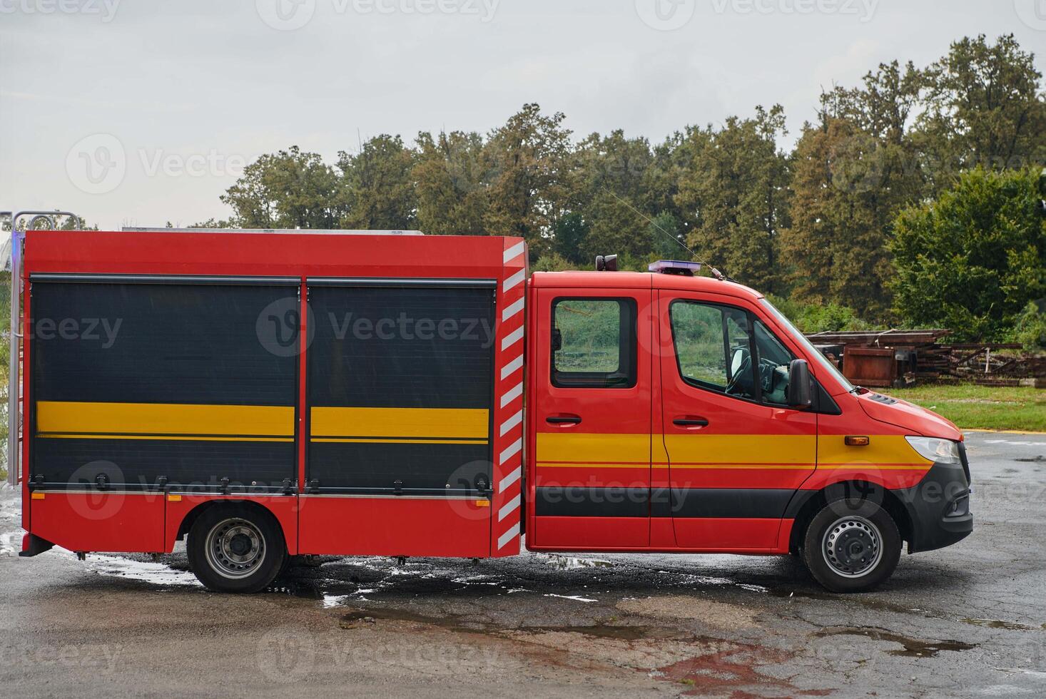 A state-of-the-art firetruck, equipped with advanced rescue technology, stands ready with its skilled firefighting team, prepared to intervene and respond rapidly to emergencies, ensuring the safety photo