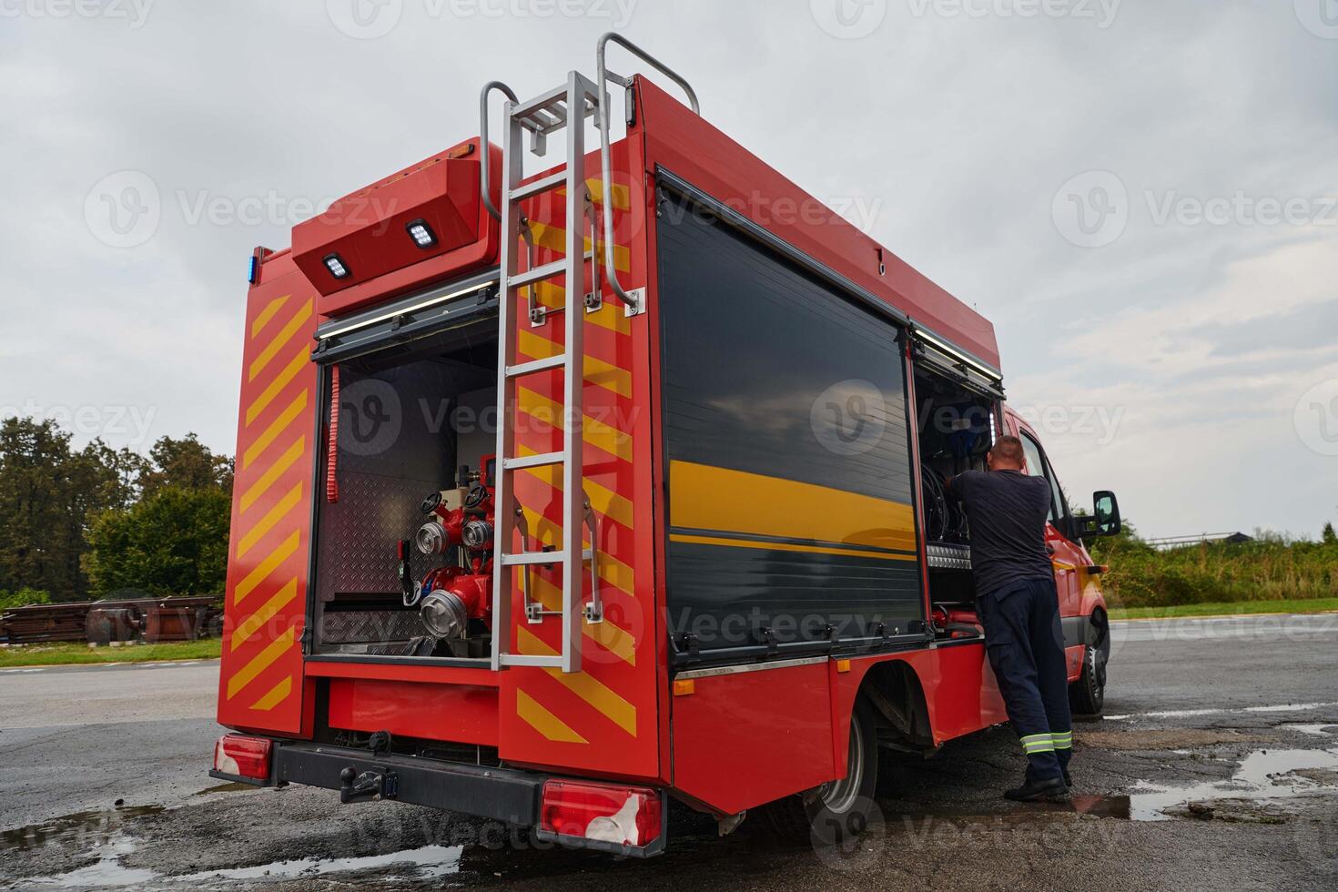 A state-of-the-art firetruck, equipped with advanced rescue technology, stands ready with its skilled firefighting team, prepared to intervene and respond rapidly to emergencies, ensuring the safety photo