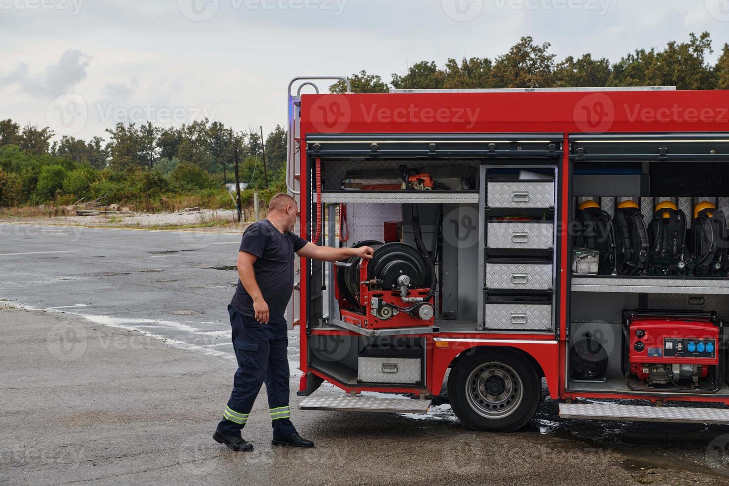 A dedicated firefighter preparing a modern firetruck for deployment to hazardous fire-stricken areas, demonstrating readiness and commitment to emergency response photo