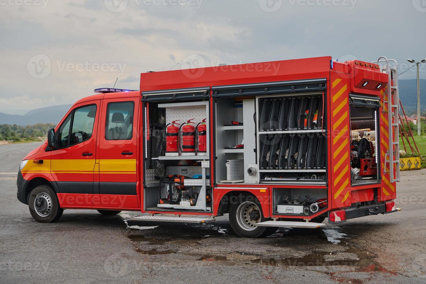 A state-of-the-art firetruck, equipped with advanced rescue technology, stands ready with its skilled firefighting team, prepared to intervene and respond rapidly to emergencies, ensuring the safety photo