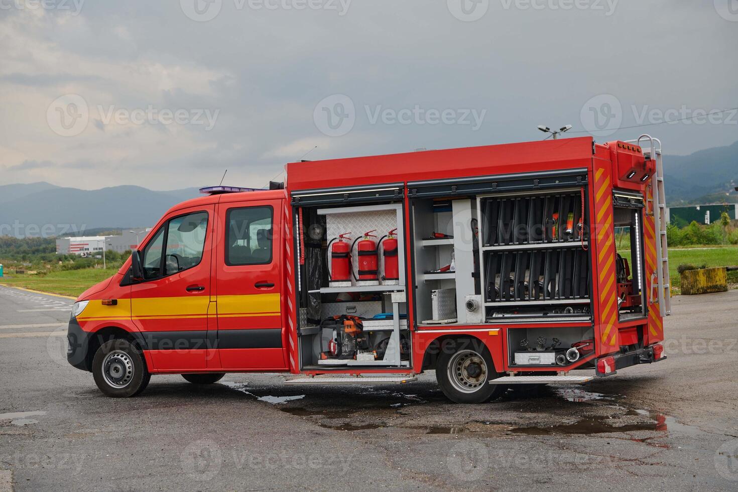 A state-of-the-art firetruck, equipped with advanced rescue technology, stands ready with its skilled firefighting team, prepared to intervene and respond rapidly to emergencies, ensuring the safety photo