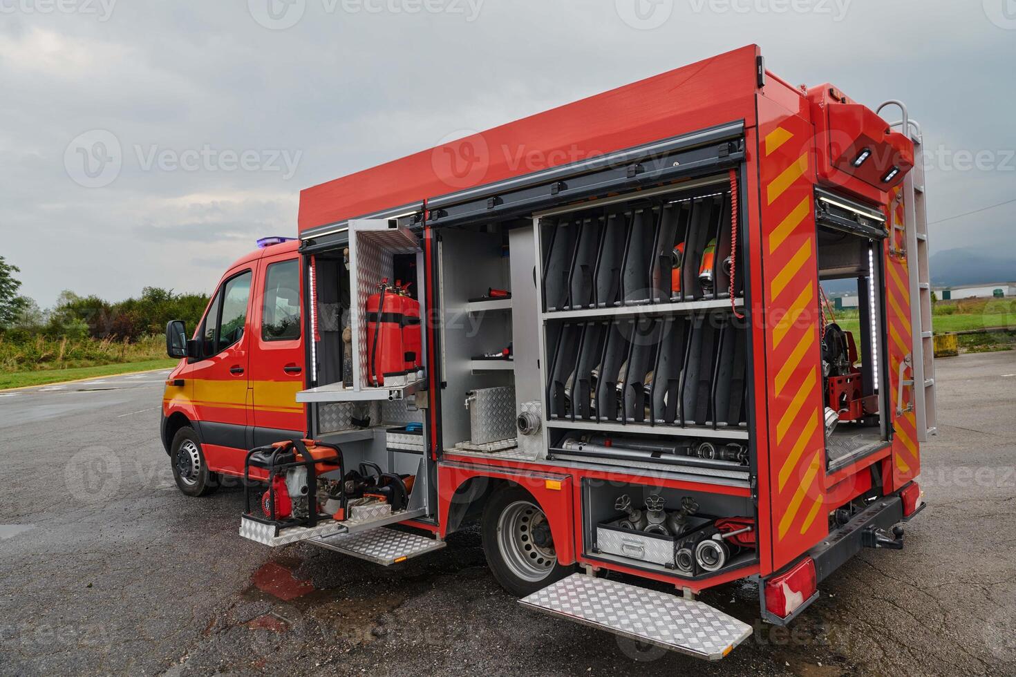 A state-of-the-art firetruck, equipped with advanced rescue technology, stands ready with its skilled firefighting team, prepared to intervene and respond rapidly to emergencies, ensuring the safety photo