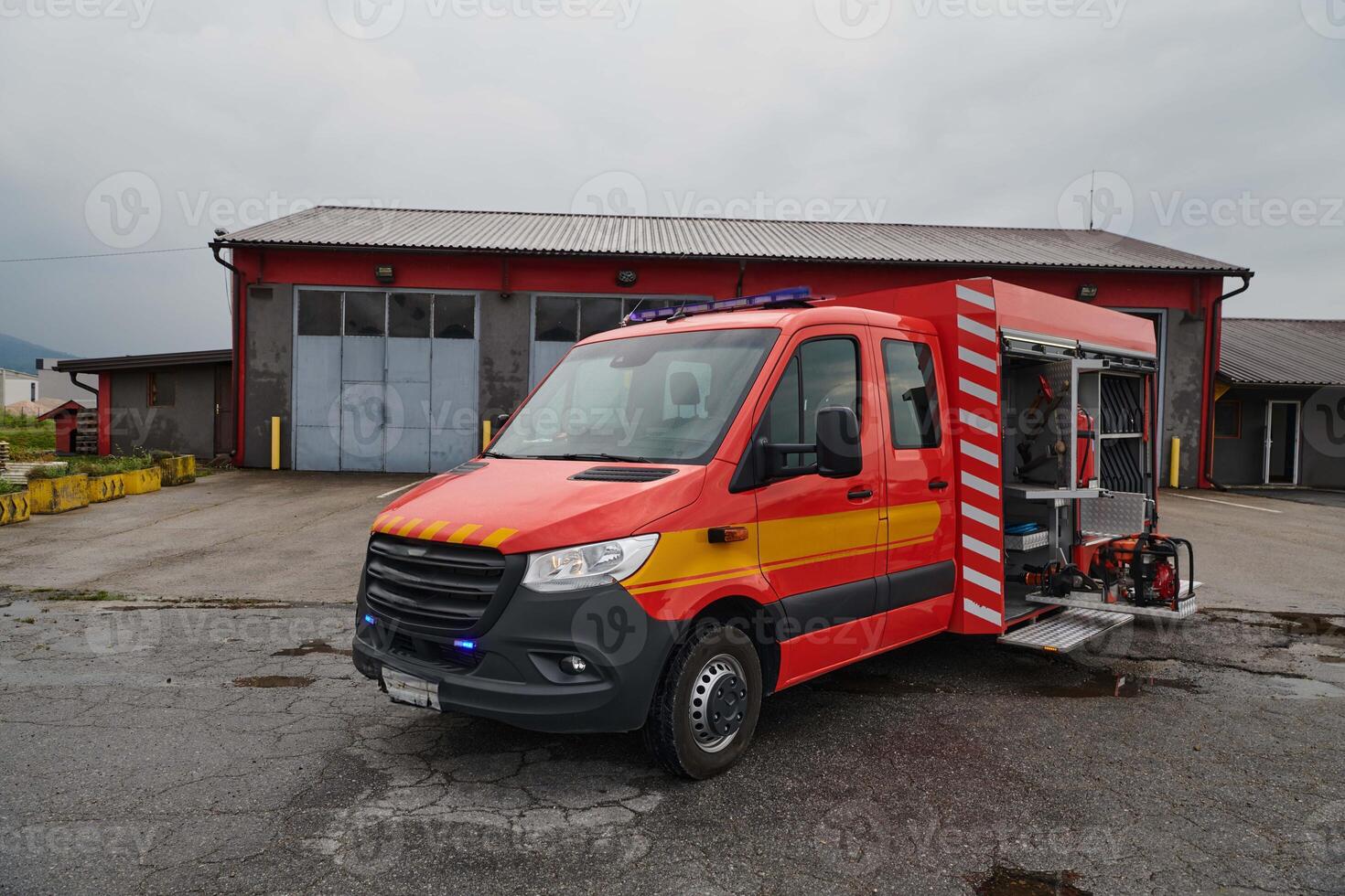 A state-of-the-art firetruck, equipped with advanced rescue technology, stands ready with its skilled firefighting team, prepared to intervene and respond rapidly to emergencies, ensuring the safety photo