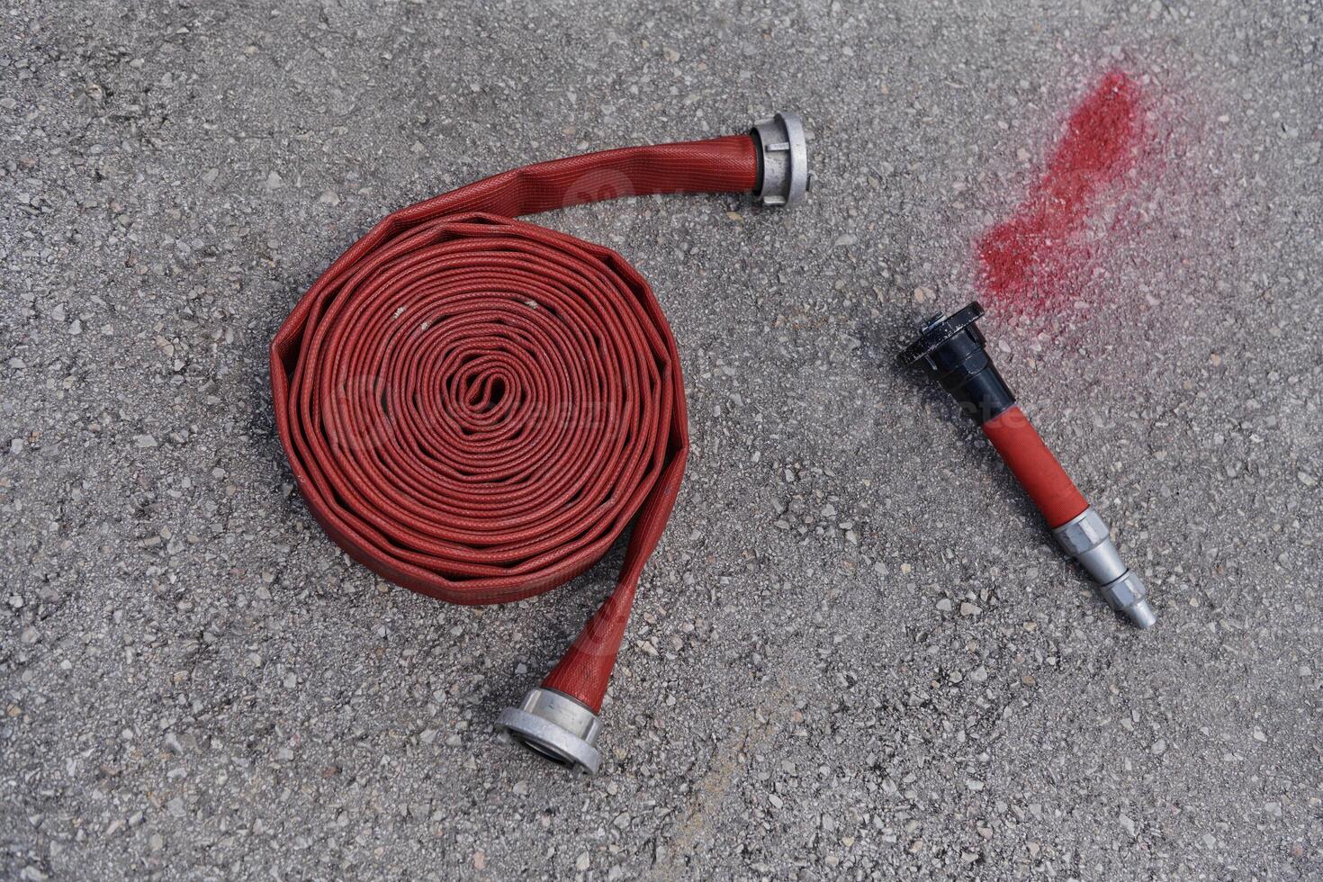 Coiled Fire Hose Ready for Action on the Ground photo
