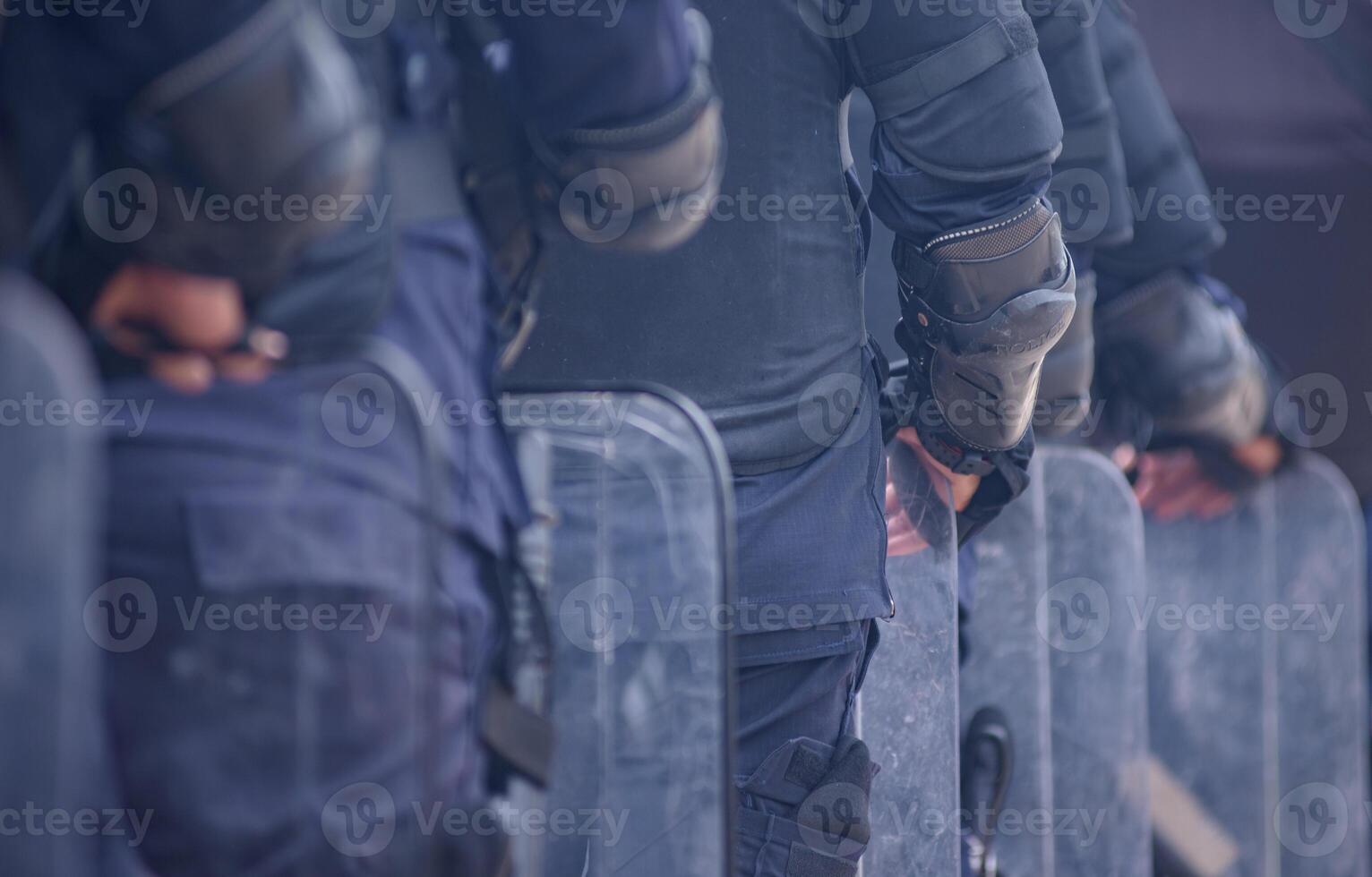Riot police practice shields and baton photo