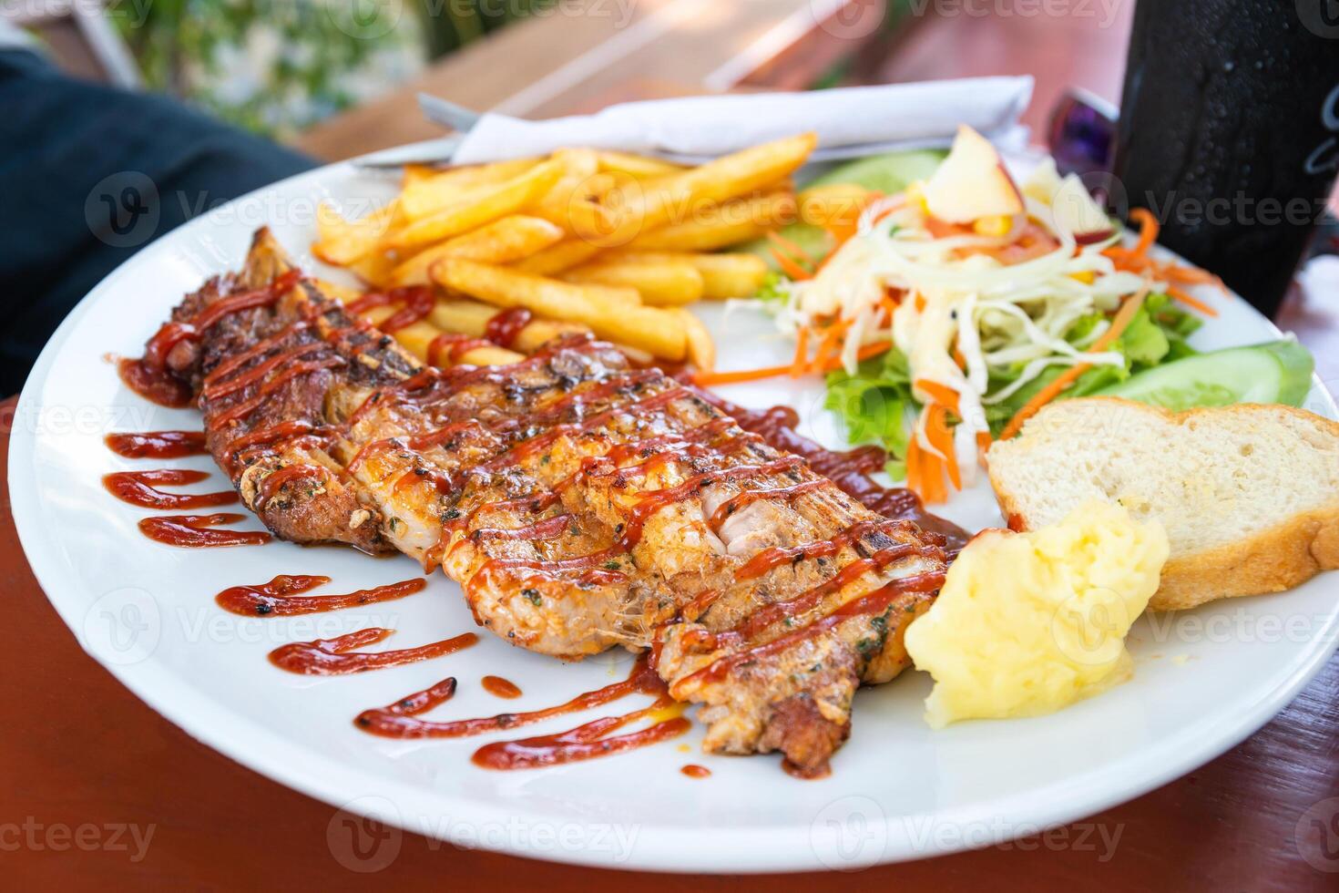 Grilled beef steak with salad on a plate photo