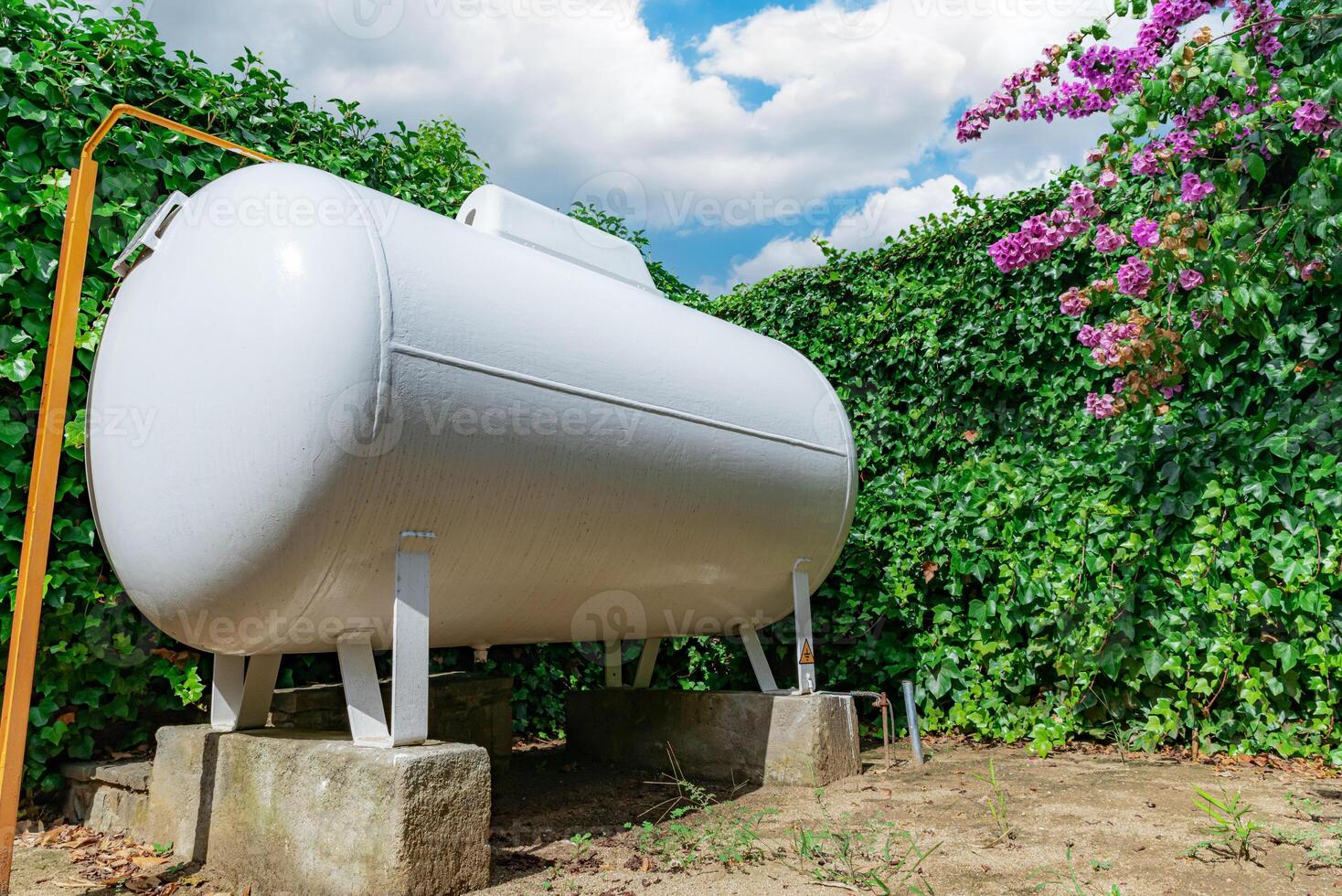 Gas storage tank in the yard against the background of the sky photo