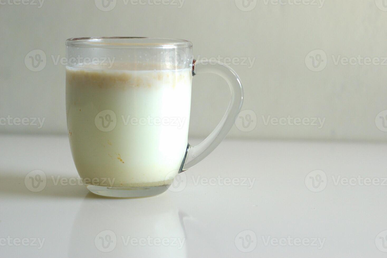 A glass of cereal in milk, transparent glass cup of cereal milk for breakfast with copy space area photo