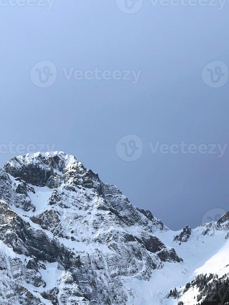 Snowy mountains on a clear day, beautiful view of the peaks photo
