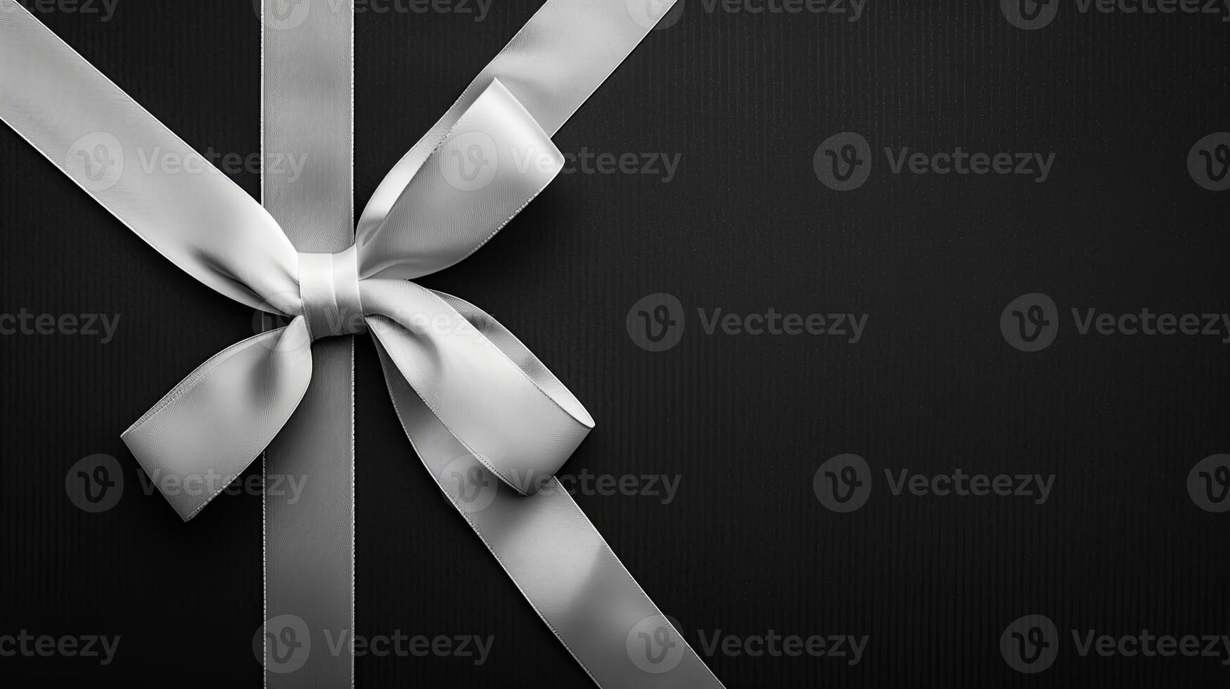 Flat lay composition of white ribbon bow atop black background. Elegant minimalism showcased. photo