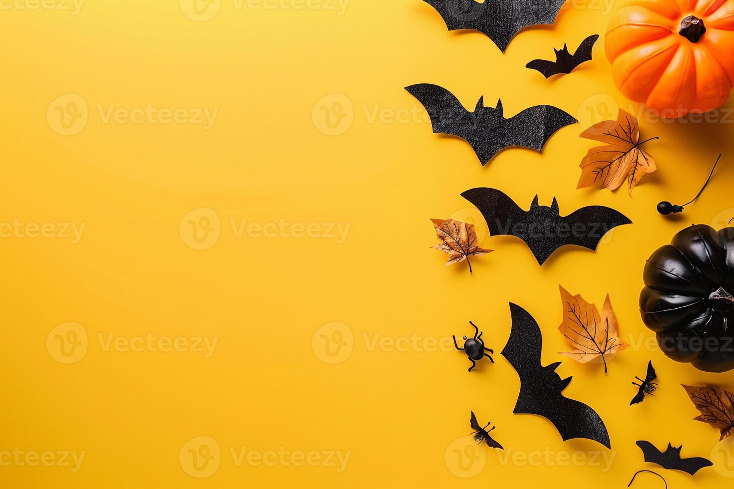 Minimalistic Halloween flat lay arrangement with bats and pumpkins on a plain white background photo