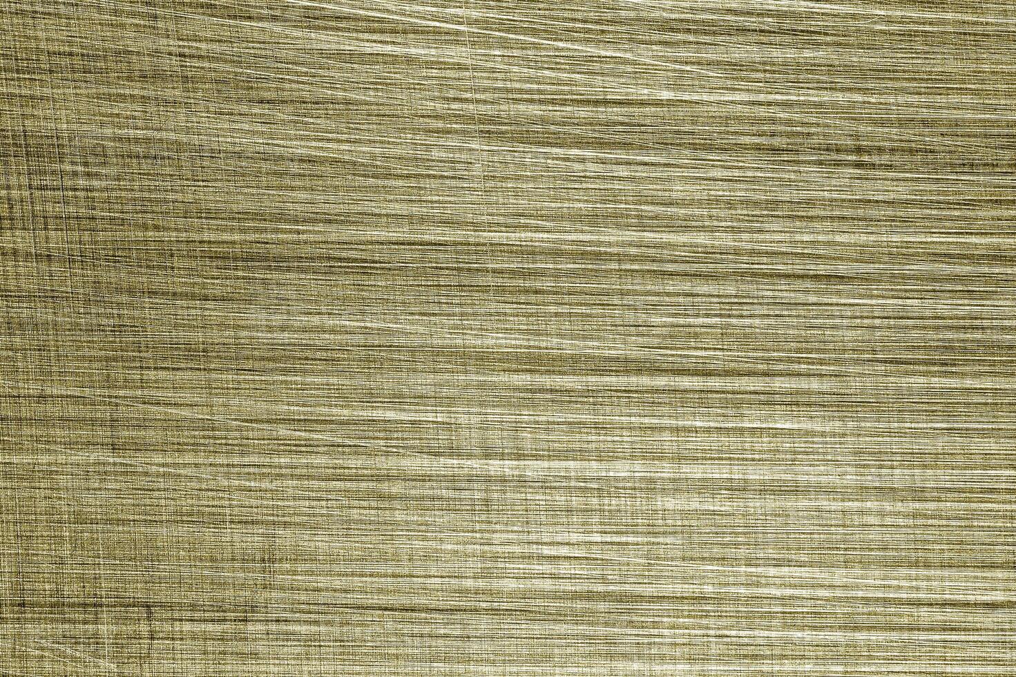 Golden texture of shiny scratched metal. Abstract gold background. photo