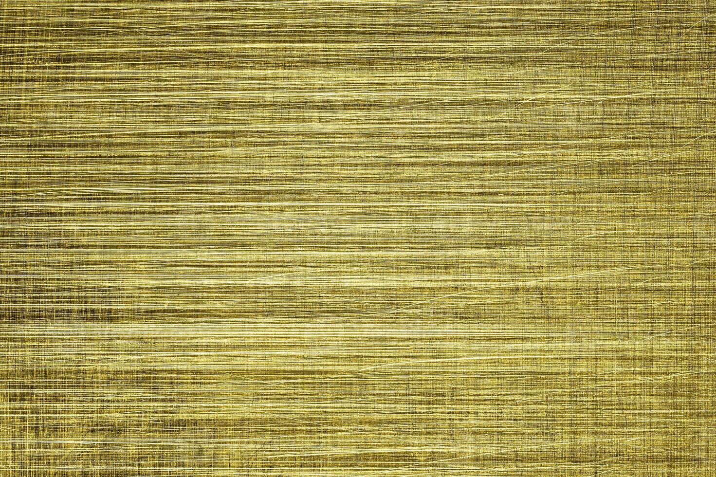 Golden texture of shiny scratched metal. Abstract gold background. photo