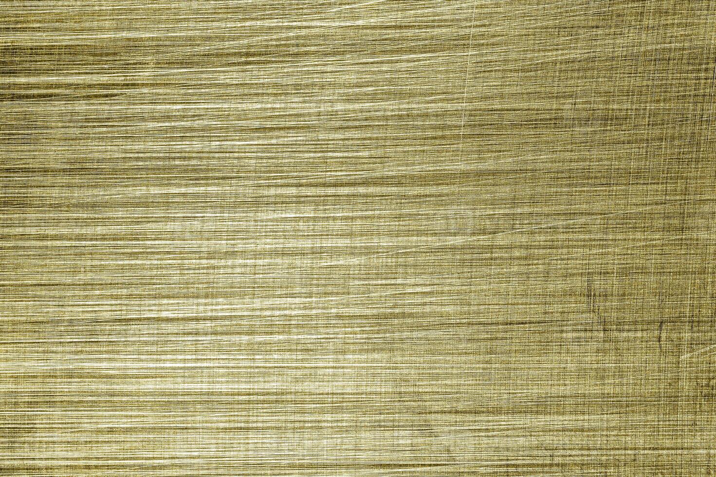 Golden texture of shiny scratched metal. Abstract gold background. photo