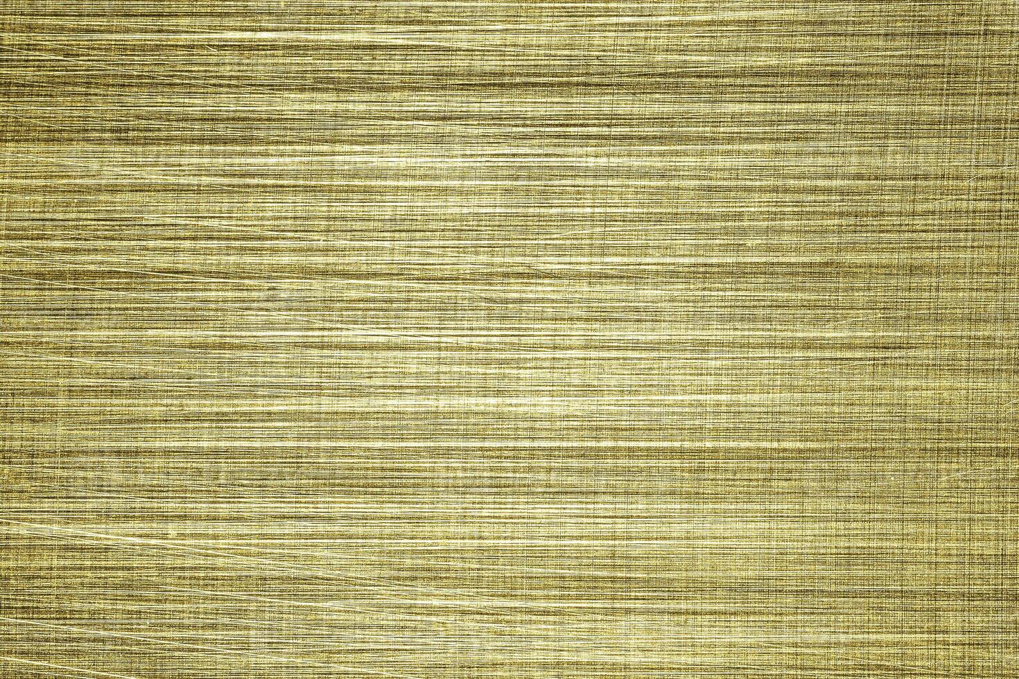 Golden texture of shiny scratched metal. Abstract gold background. photo