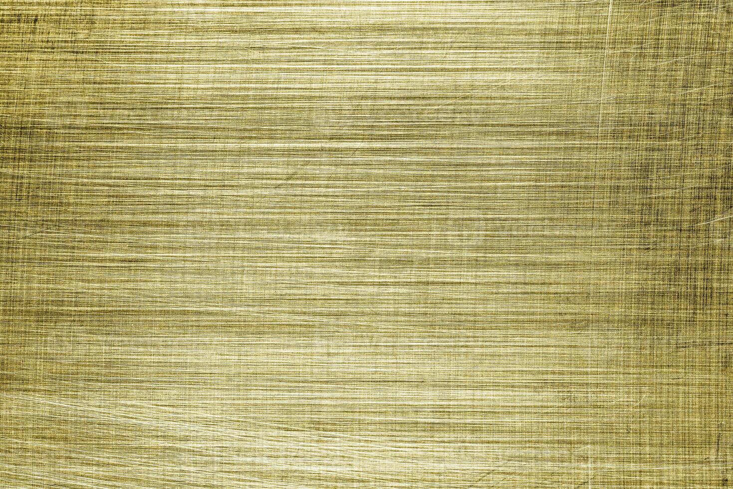 Golden texture of shiny scratched metal. Abstract gold background. photo