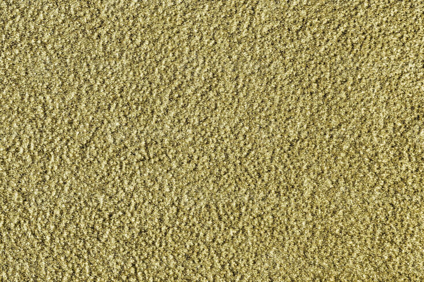Golden texture of shiny grained metal. Abstract gold background. photo