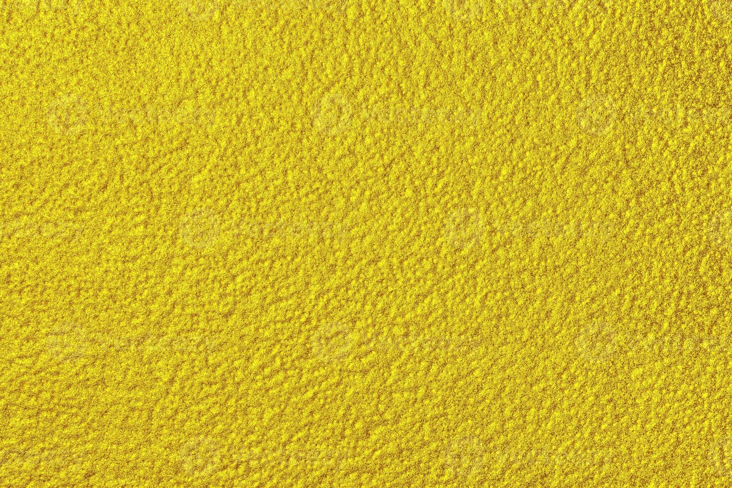 Golden texture of shiny grained metal. Abstract gold background. photo