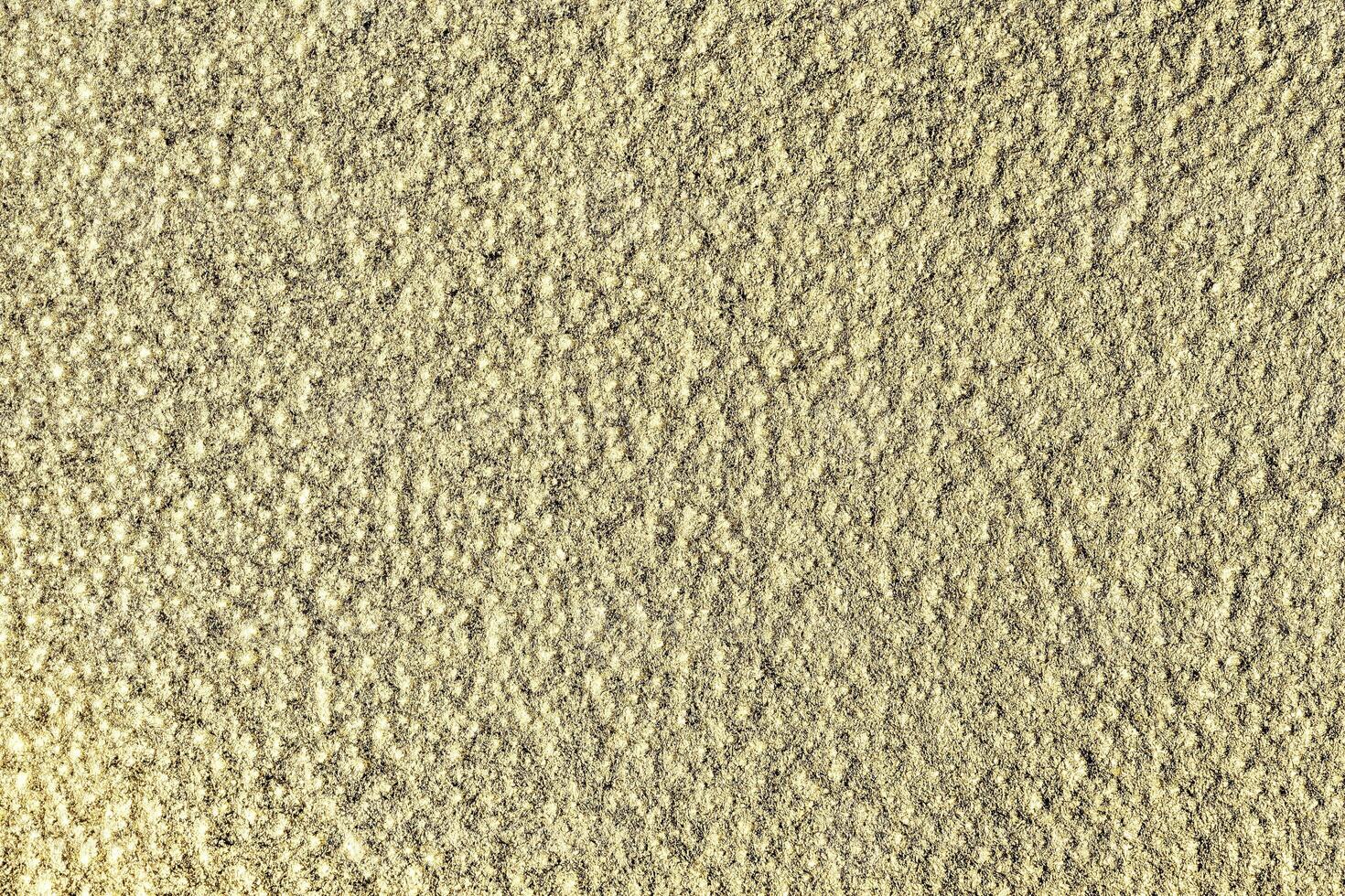 Golden texture of shiny grained metal. Abstract gold background. photo