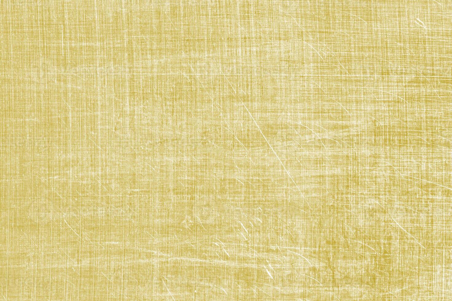 Golden texture of shiny scratched metal. Abstract gold background. photo