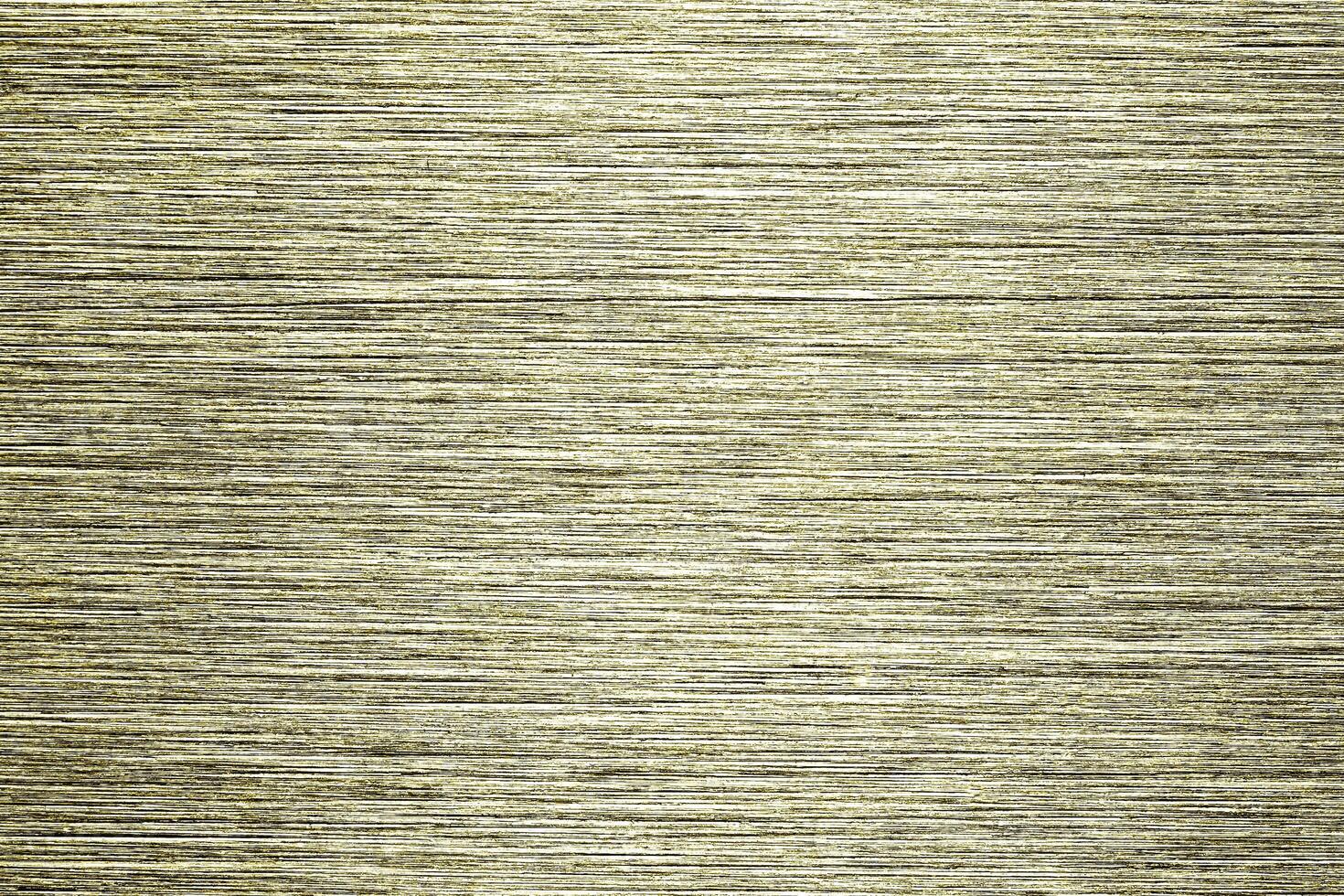 Golden texture of shiny scratched metal. Abstract gold background. photo