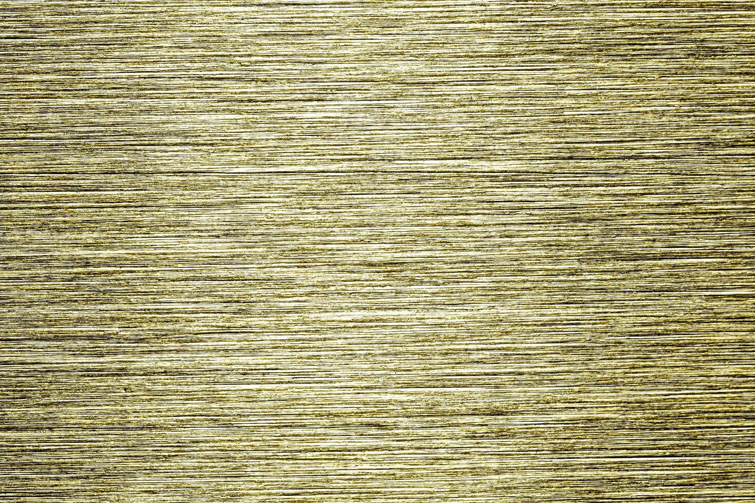 Golden texture of shiny scratched metal. Abstract gold background. photo