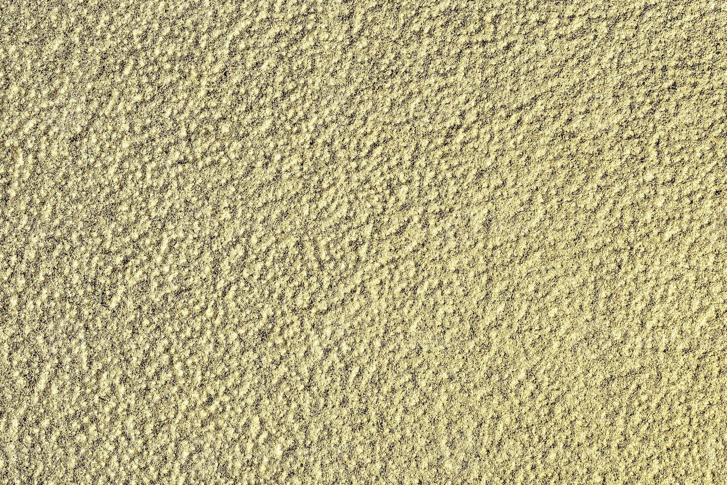 Golden texture of shiny grained metal. Abstract gold background. photo