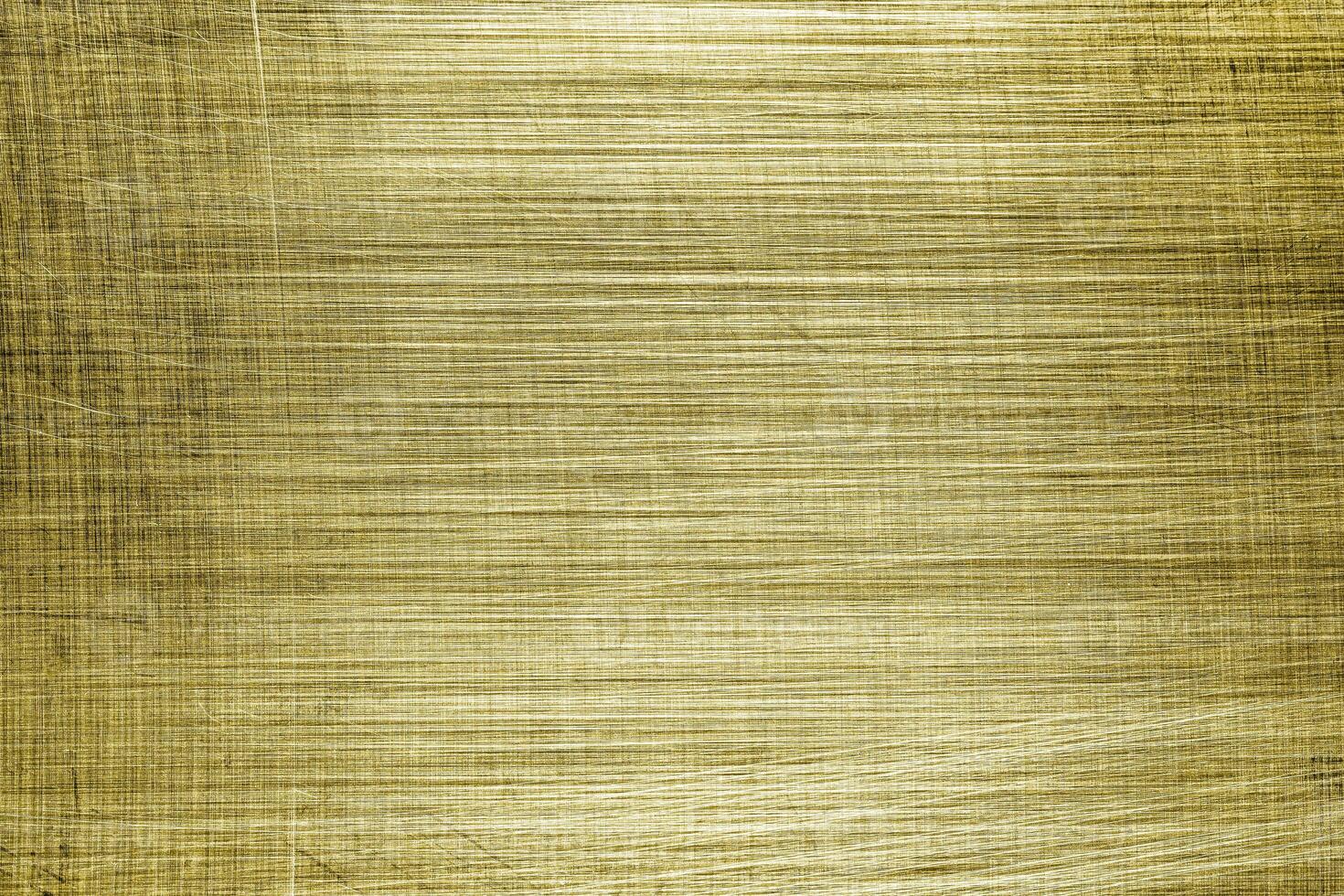 Golden texture of shiny scratched metal. Abstract gold background. photo