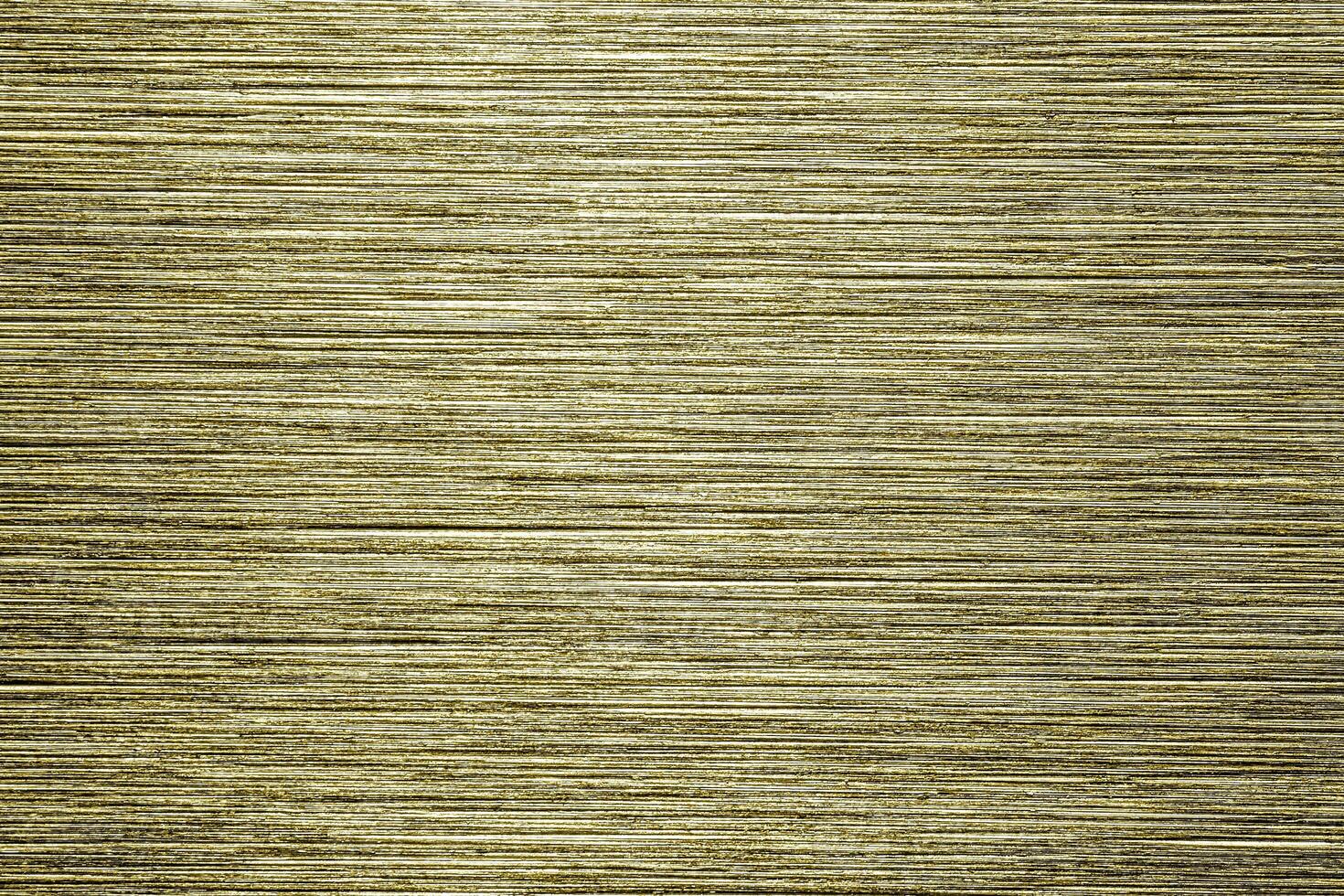 Golden texture of shiny scratched metal. Abstract gold background. photo