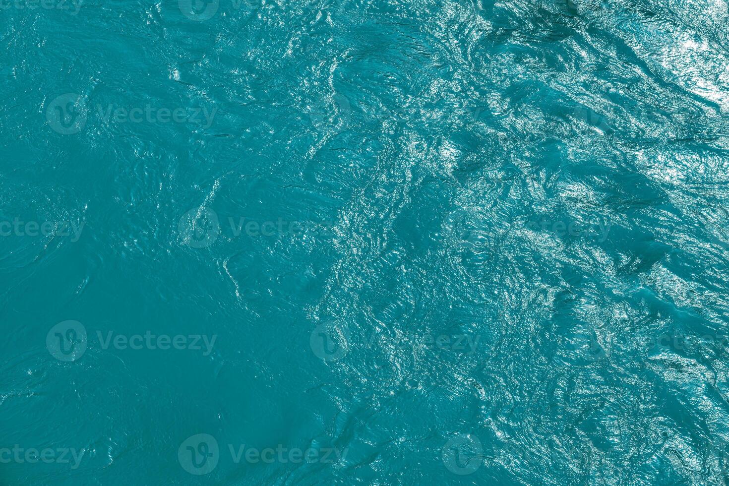 The texture of the waves of blue color of fast-flowing water in the river. photo