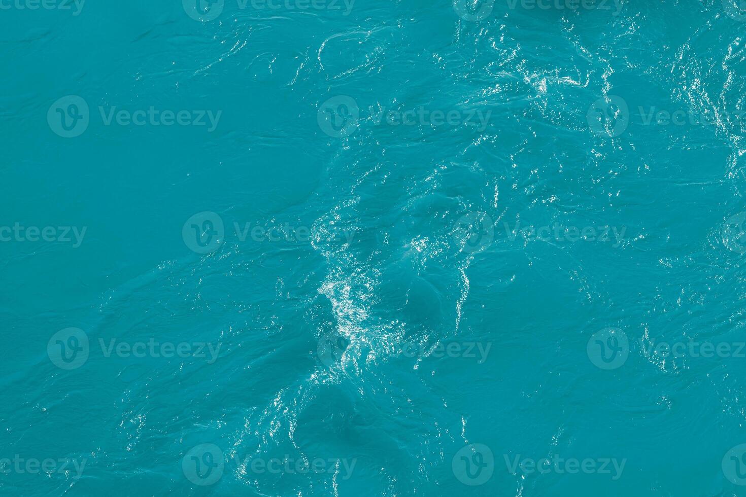 The texture of the waves of blue color of fast-flowing water in the river. photo