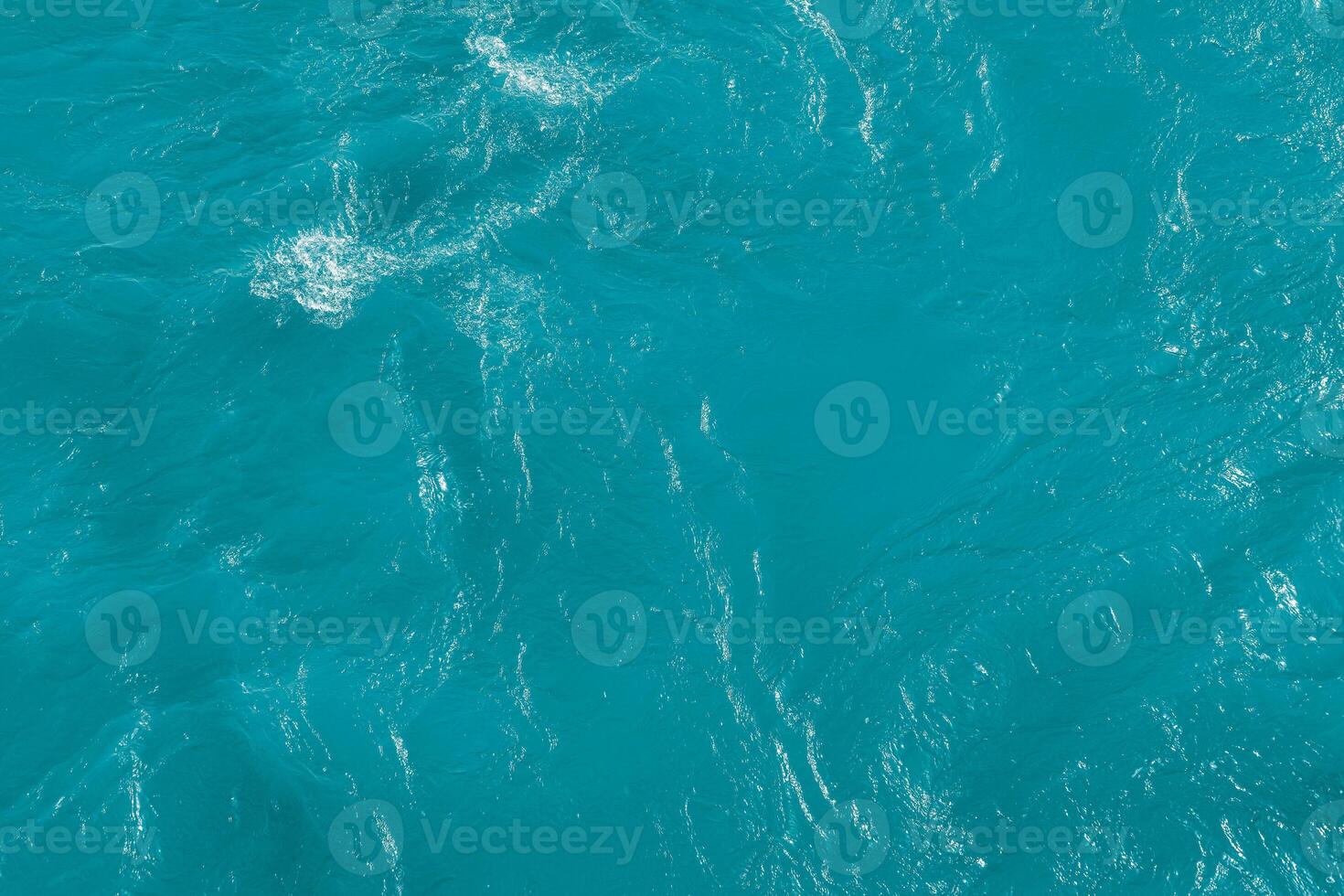 The texture of the waves of blue color of fast-flowing water in the river. photo