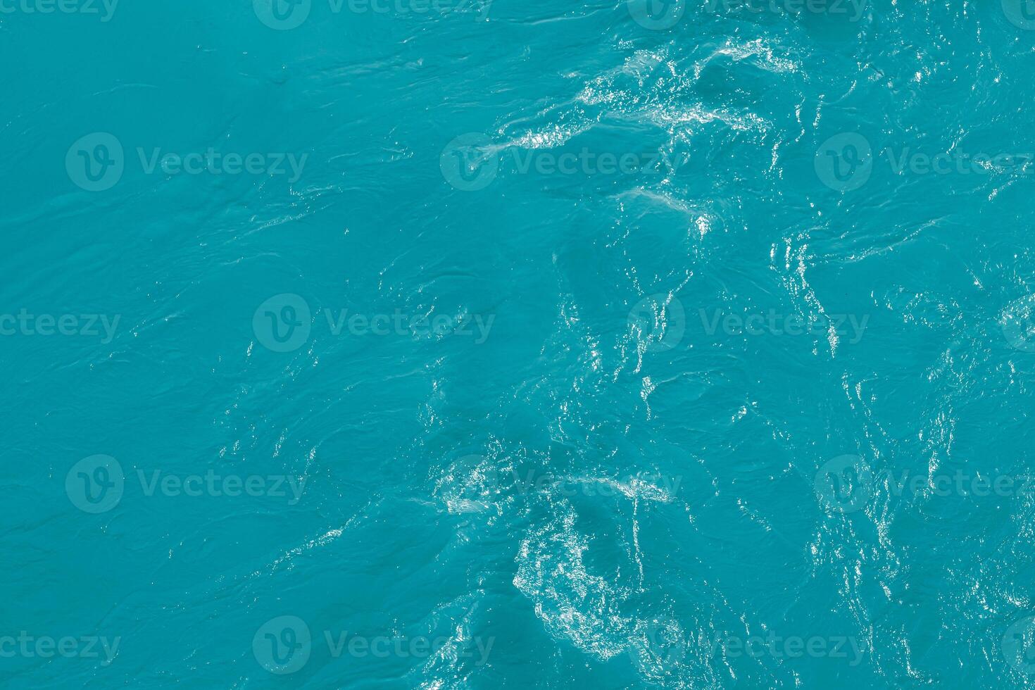 The texture of the waves of blue color of fast-flowing water in the river. photo