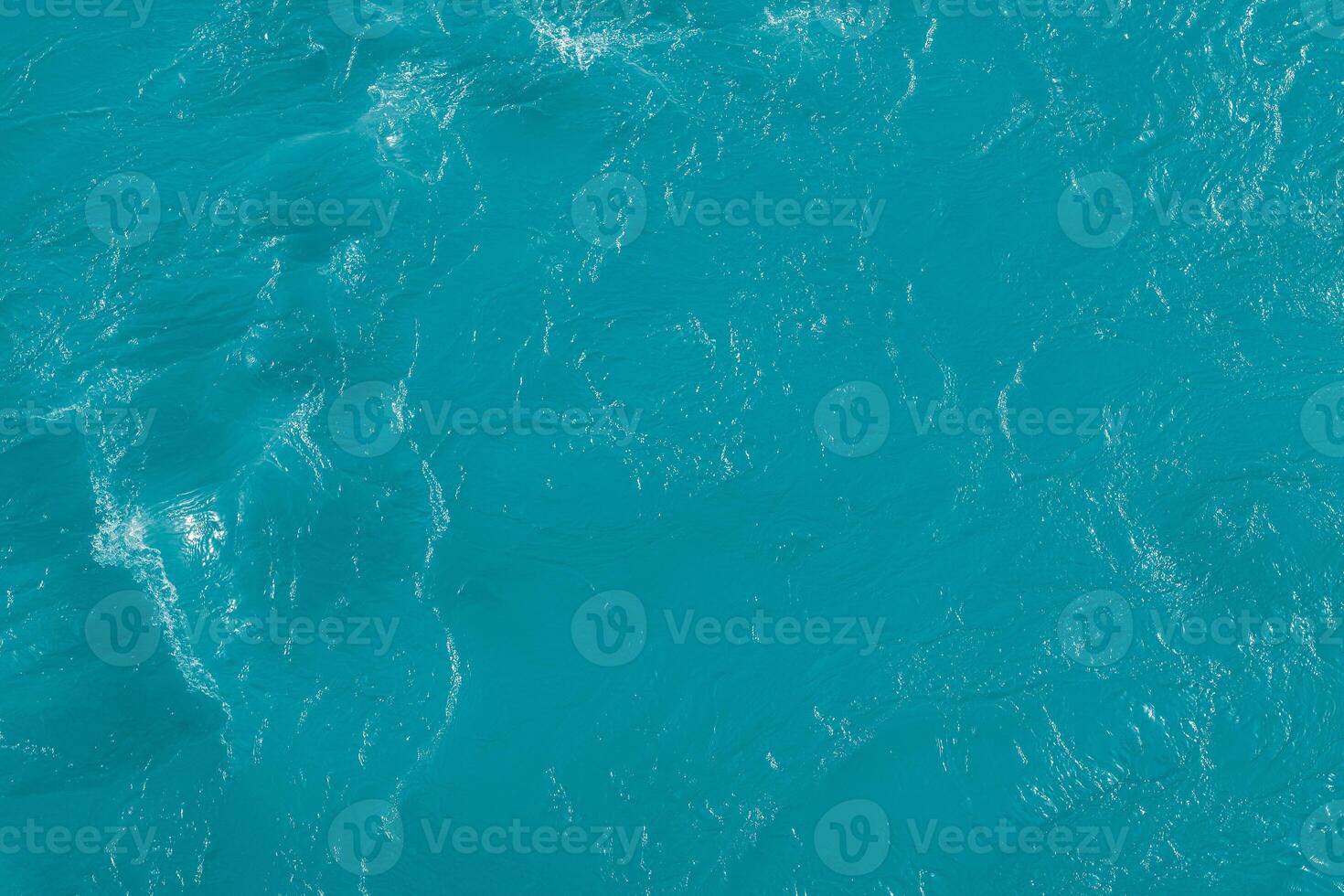 The texture of the waves of blue color of fast-flowing water in the river. photo