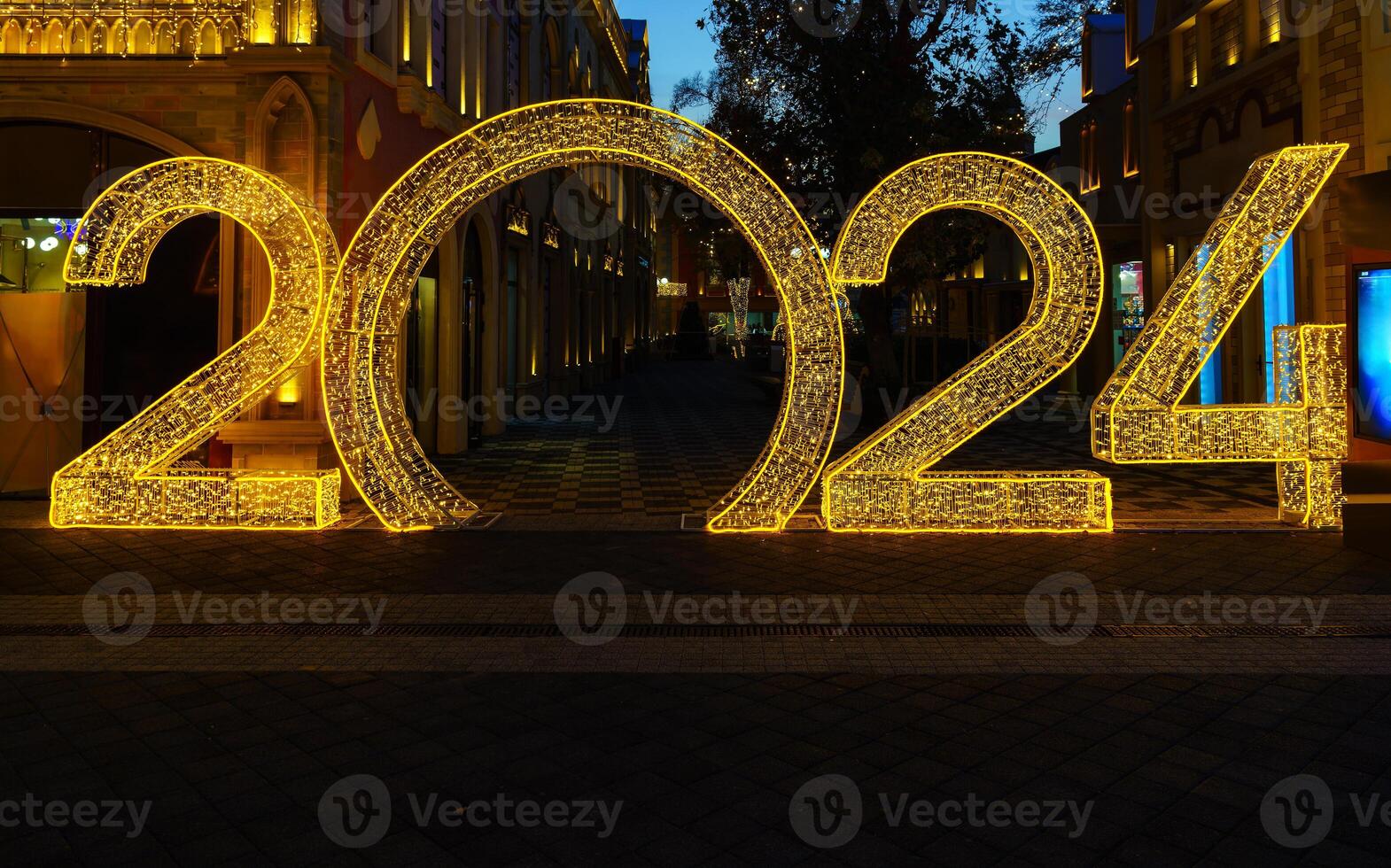 Christmas decoration in the form of the number 2024 from luminous garlands at night. photo