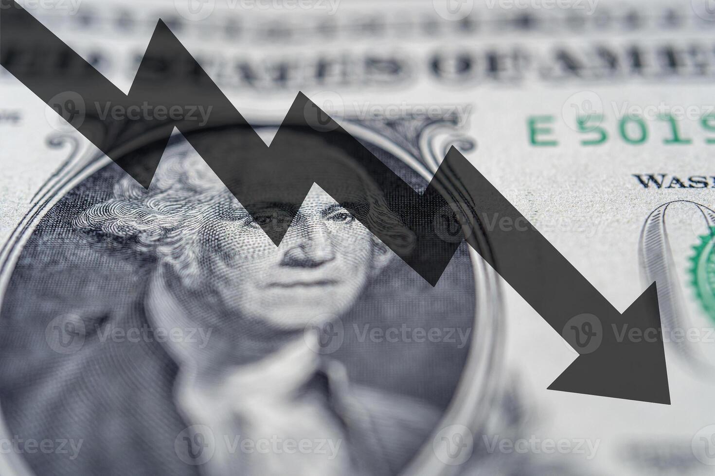 Arrow down on the background of dollar bill. The concept of inflation, depreciation of the dollar or the US economy. photo