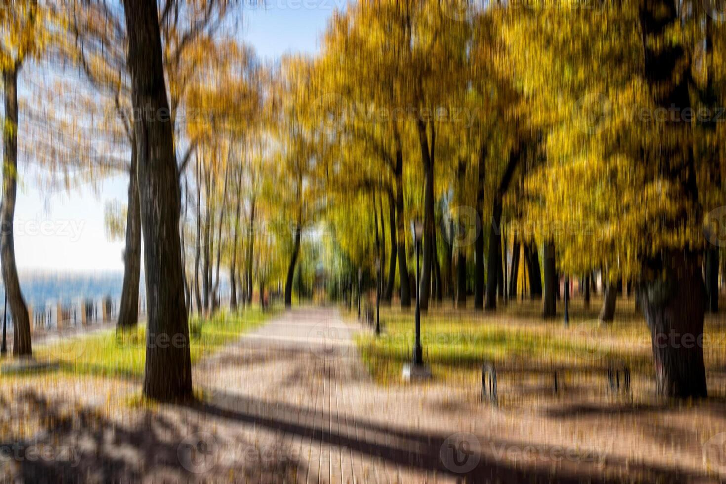 Autumn park vertical motion blurr background. Fall season abstract. photo