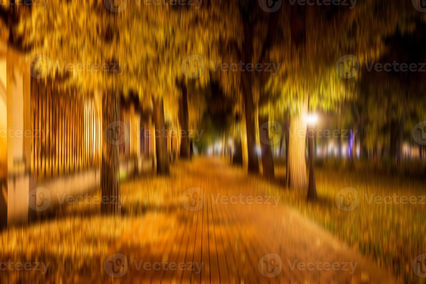 Autumn night park vertical motion blurr background. Fall season abstract. photo