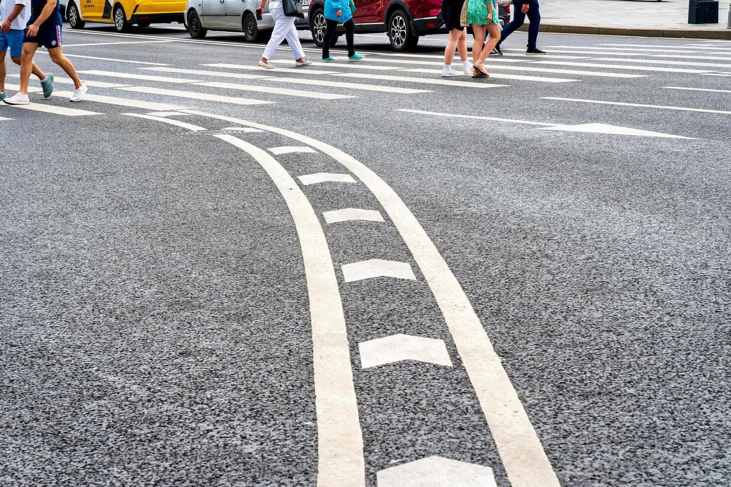 MOSCOW, RUSSIA, 17 JULY, 2022 People crossing the road at the pedestrian crossing. photo