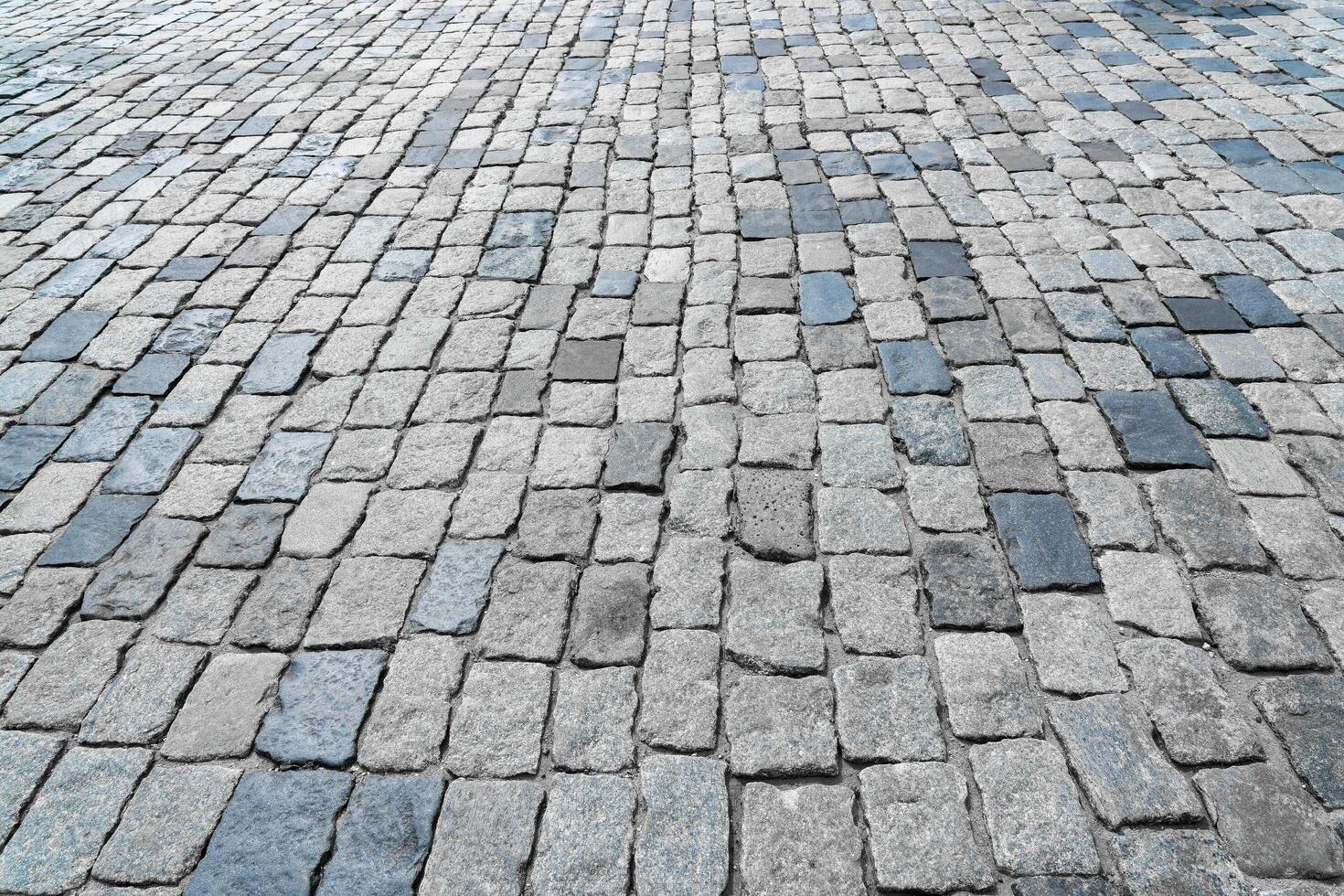 The texture of a stone old pavement with a perspective. photo