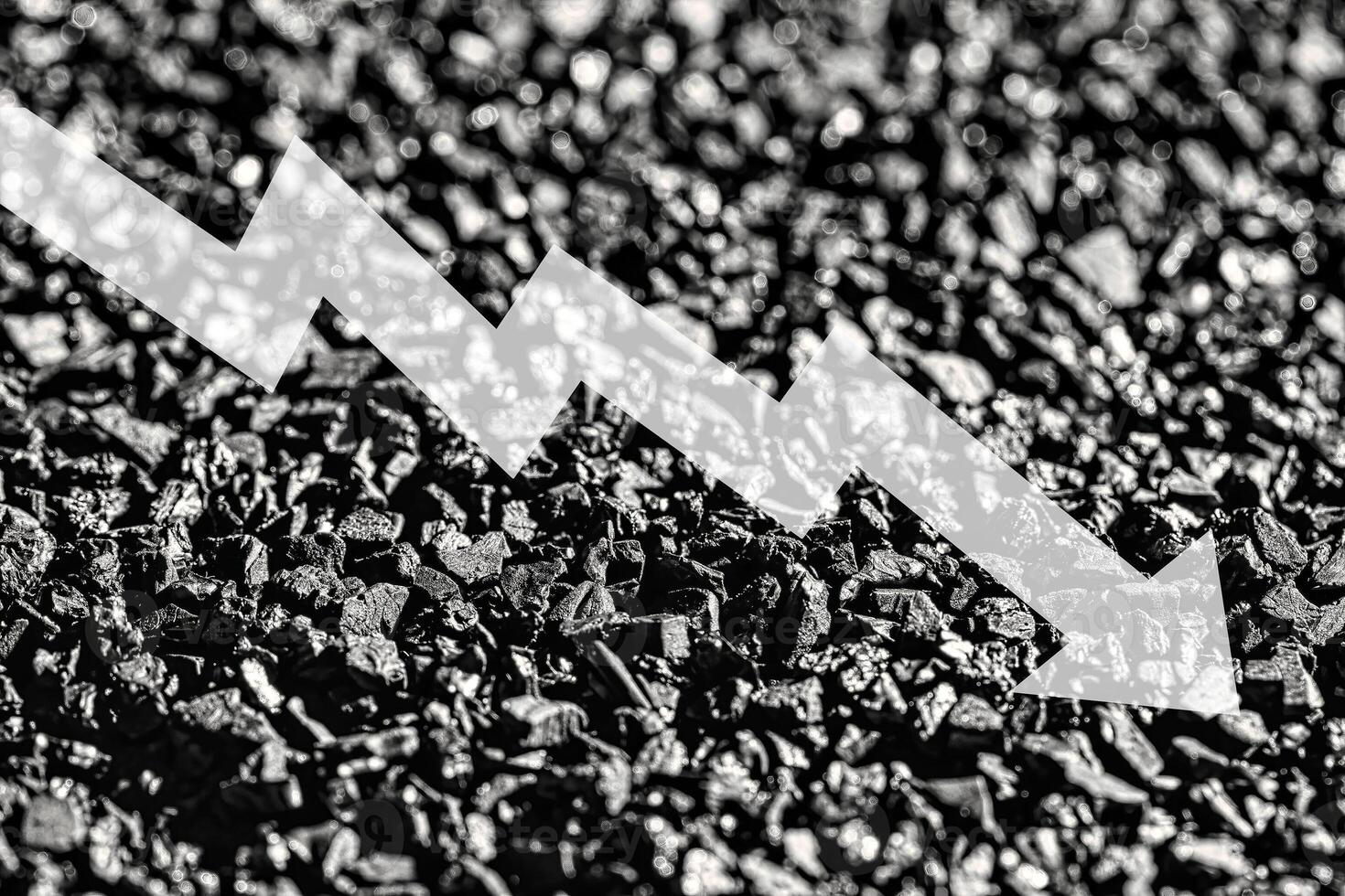 Arrow down on coal background. The concept of falling prices, mining, import, export, production or sales of coal. photo