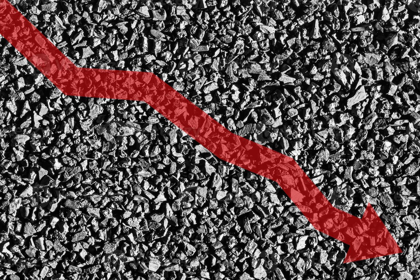 Arrow down on coal background. The concept of falling prices, mining, import, export, production or sales of coal. photo