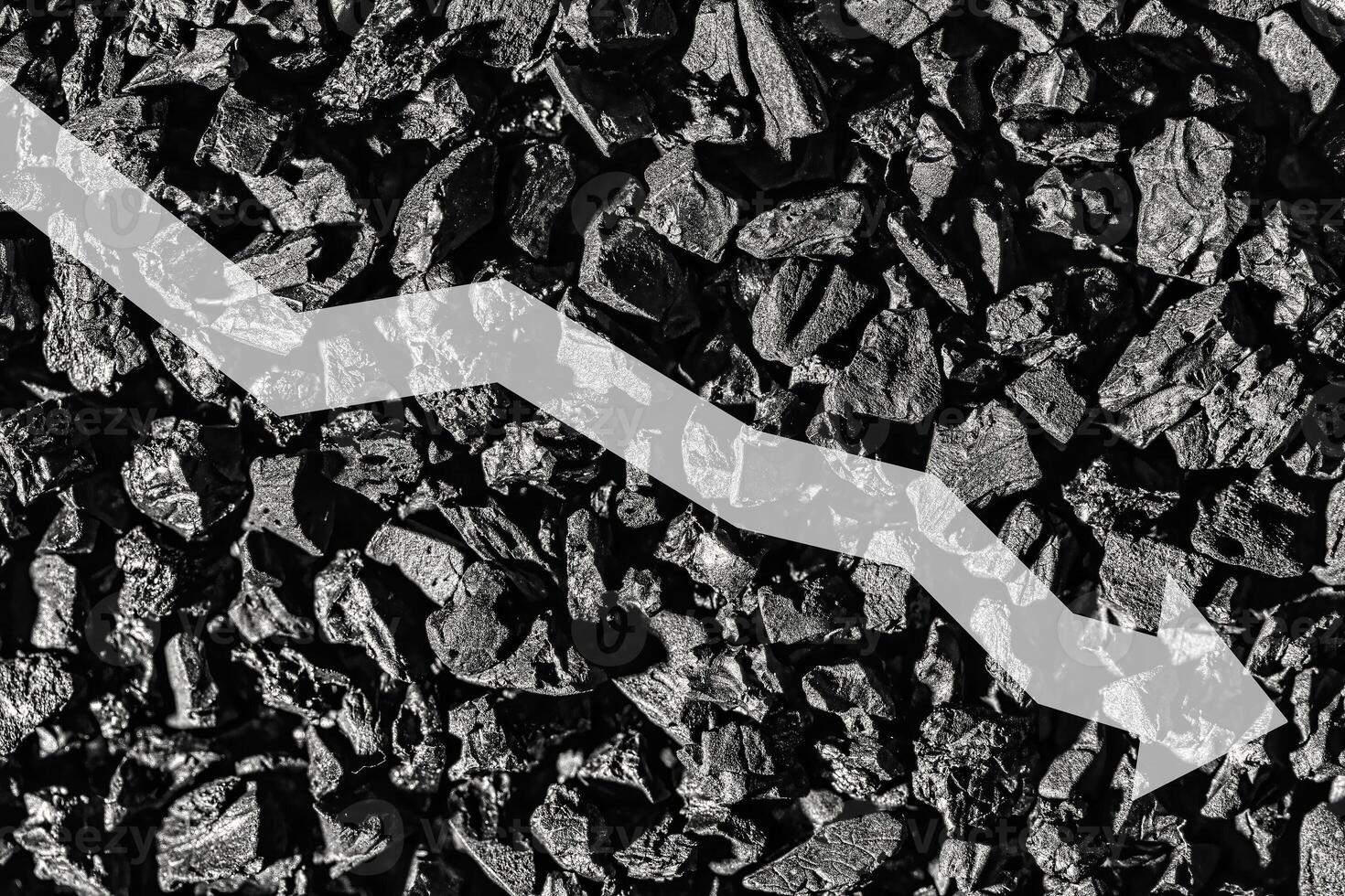 Arrow down on coal background. The concept of falling prices, mining, import, export, production or sales of coal. photo