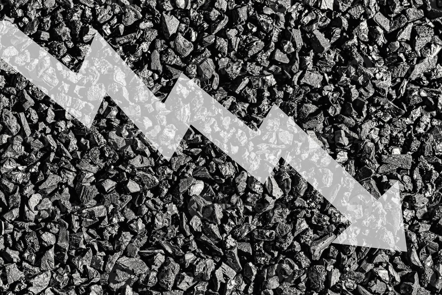 Arrow down on coal background. The concept of falling prices, mining, import, export, production or sales of coal. photo