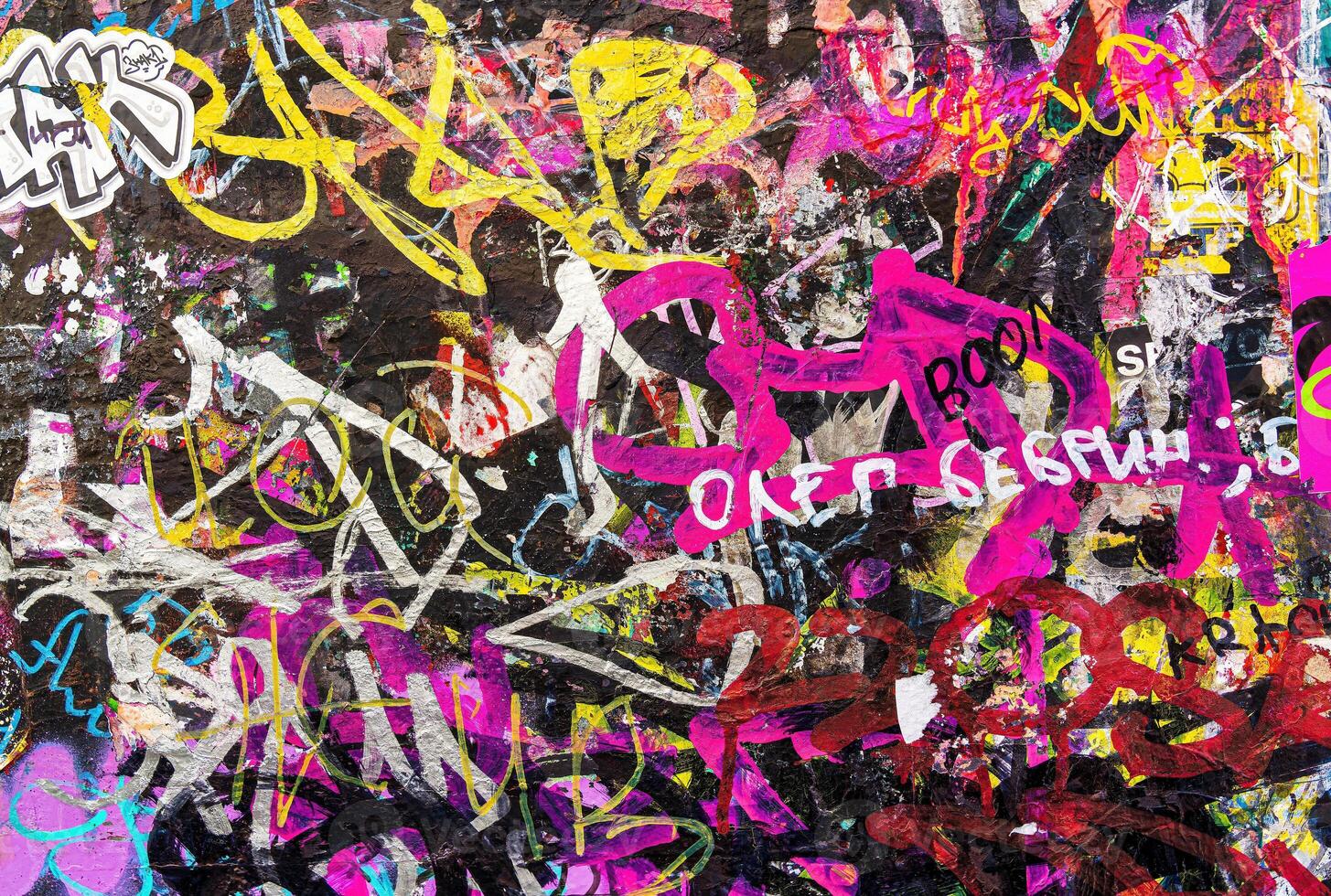 Colorful graffiti painted on a wall. Abstract urban background. Spray painting art. photo